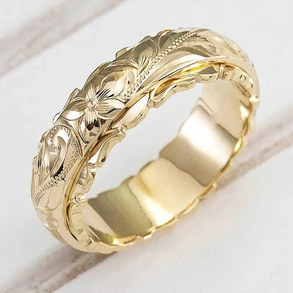 Anillo ancho con motivo floral cincelado en acabado dorado